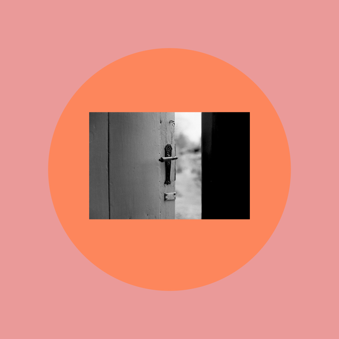 An orange circle with a black and white photo of a door.
