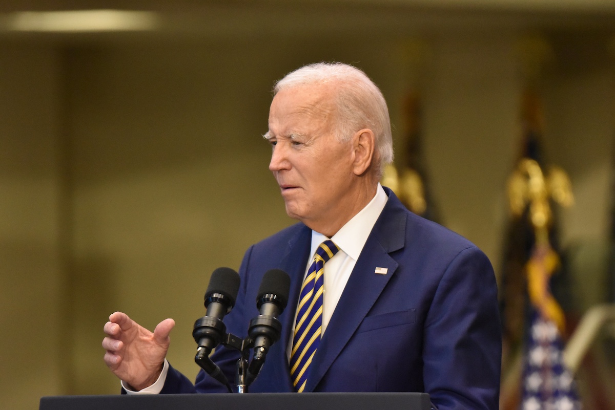 Joe biden speaking at a podium.