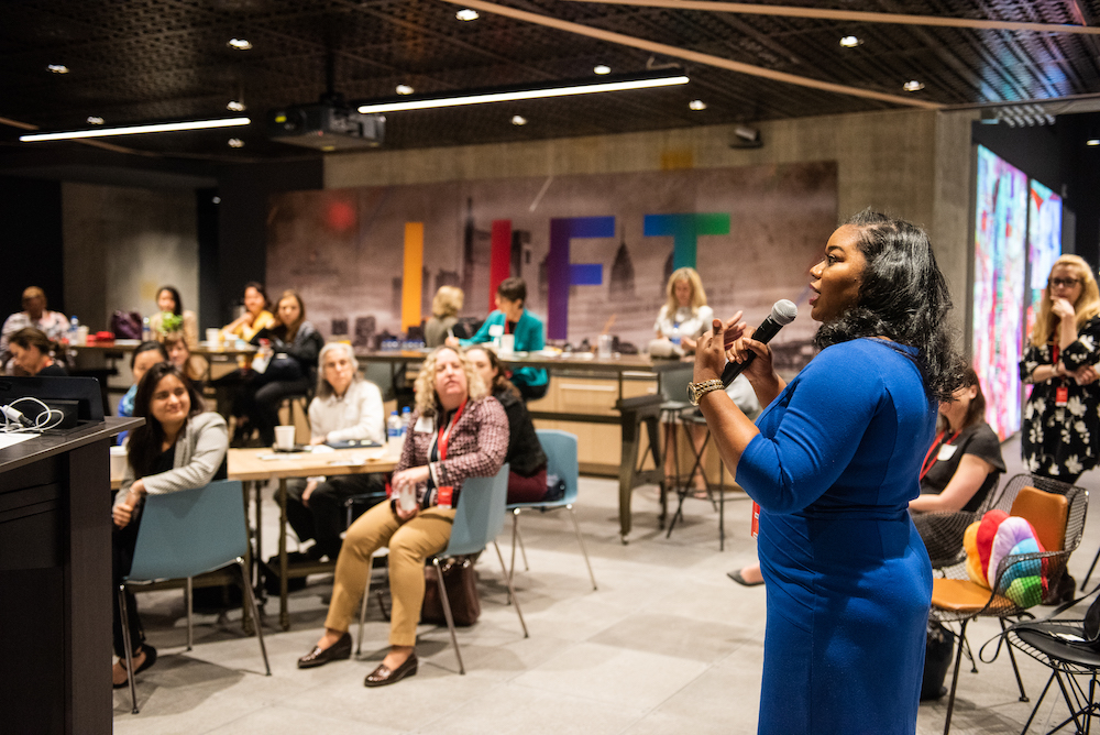 A woman speaking to a group in the LIFT Labs office.