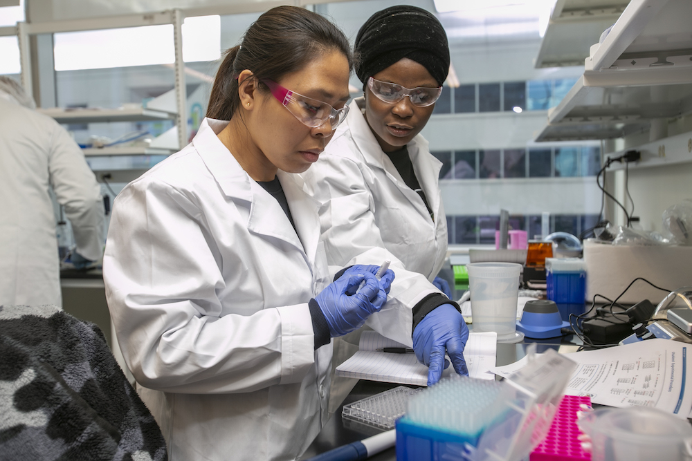Photo of two women working in a biotech lab.