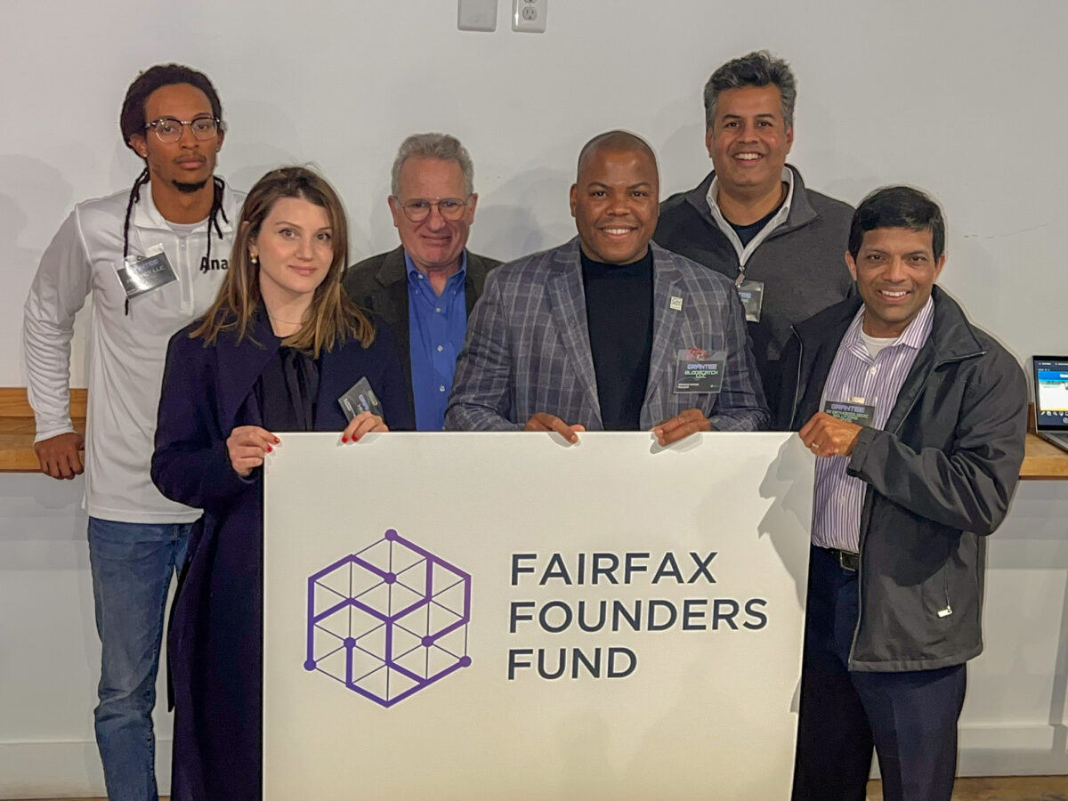 A group of six people standing together, holding a sign that reads "Fairfax Founders Fund.