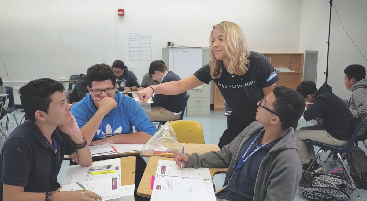 A teacher teaches a group of students in a classroom.