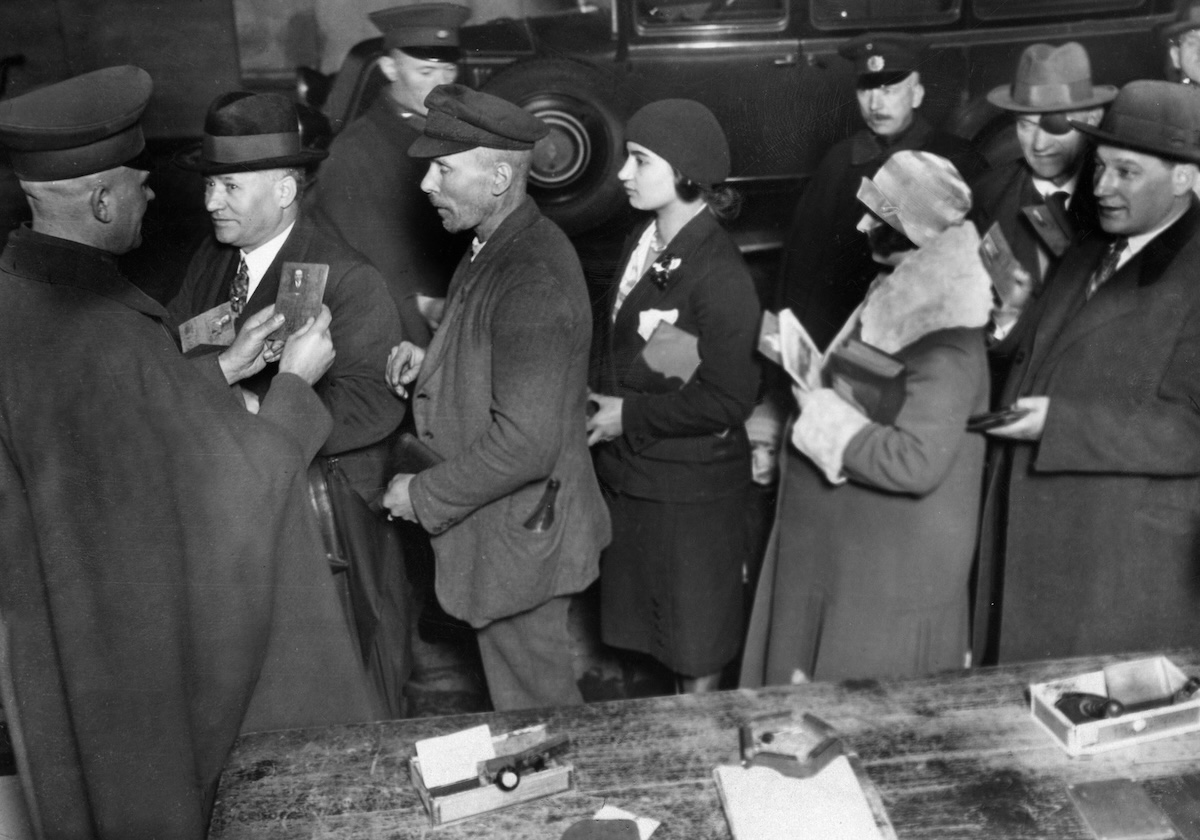 A group of people standing around a table.