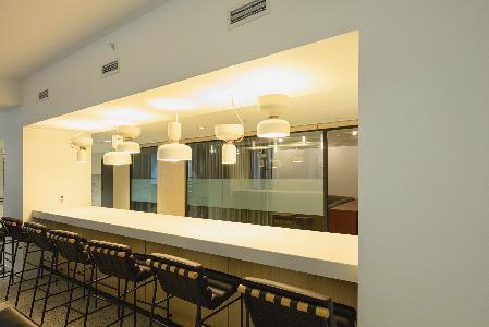 A bar with black stools.