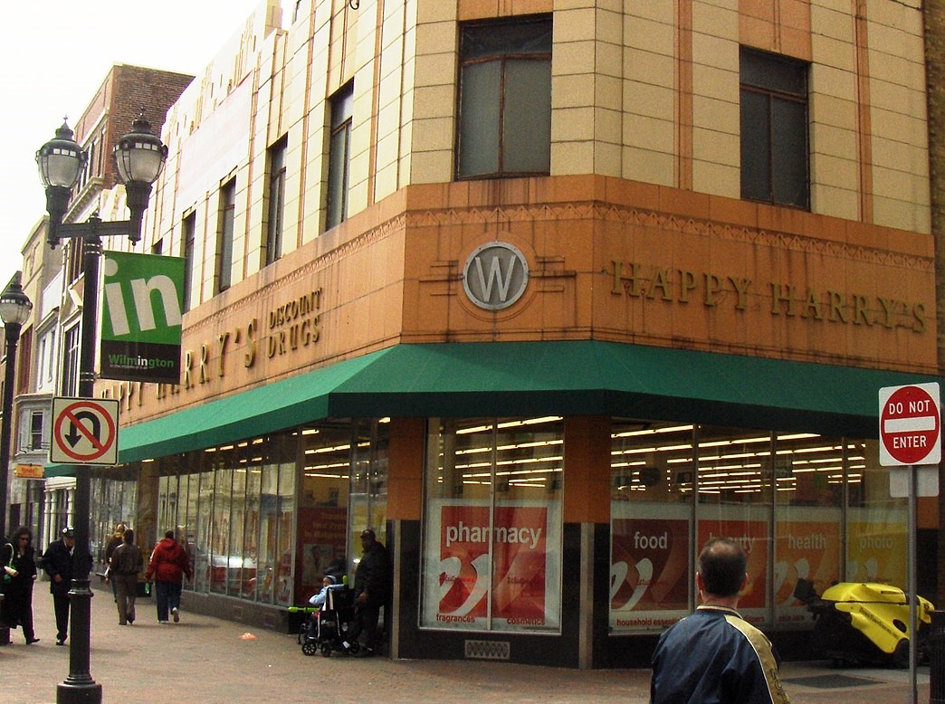 A brick building with a green awning.