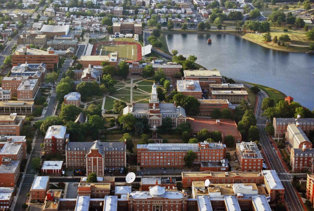 Aerial photo of Howard University with red buildings and green campus