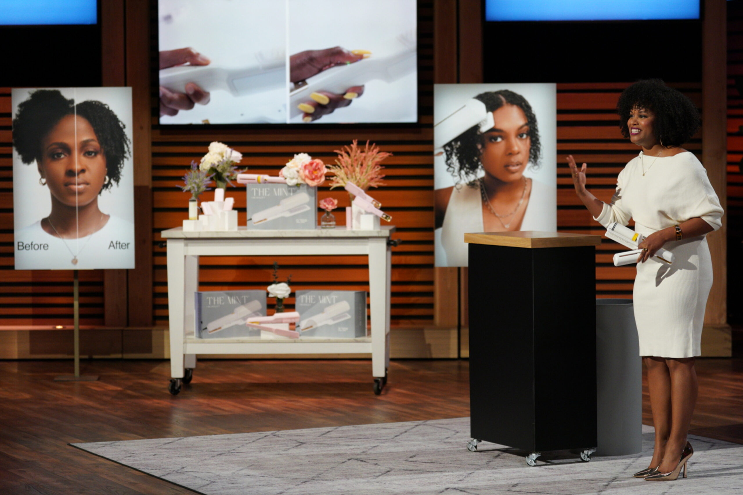 Dawn Myers in white dress near her company's haircare products for Black women on "Shark Tank."