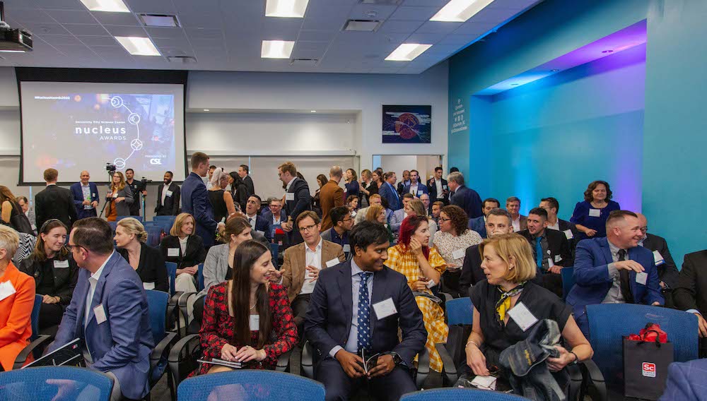 Attendees mingling in a conference room before a business event.