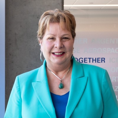 Headshot of Donna Meshaka in a teal blazer.