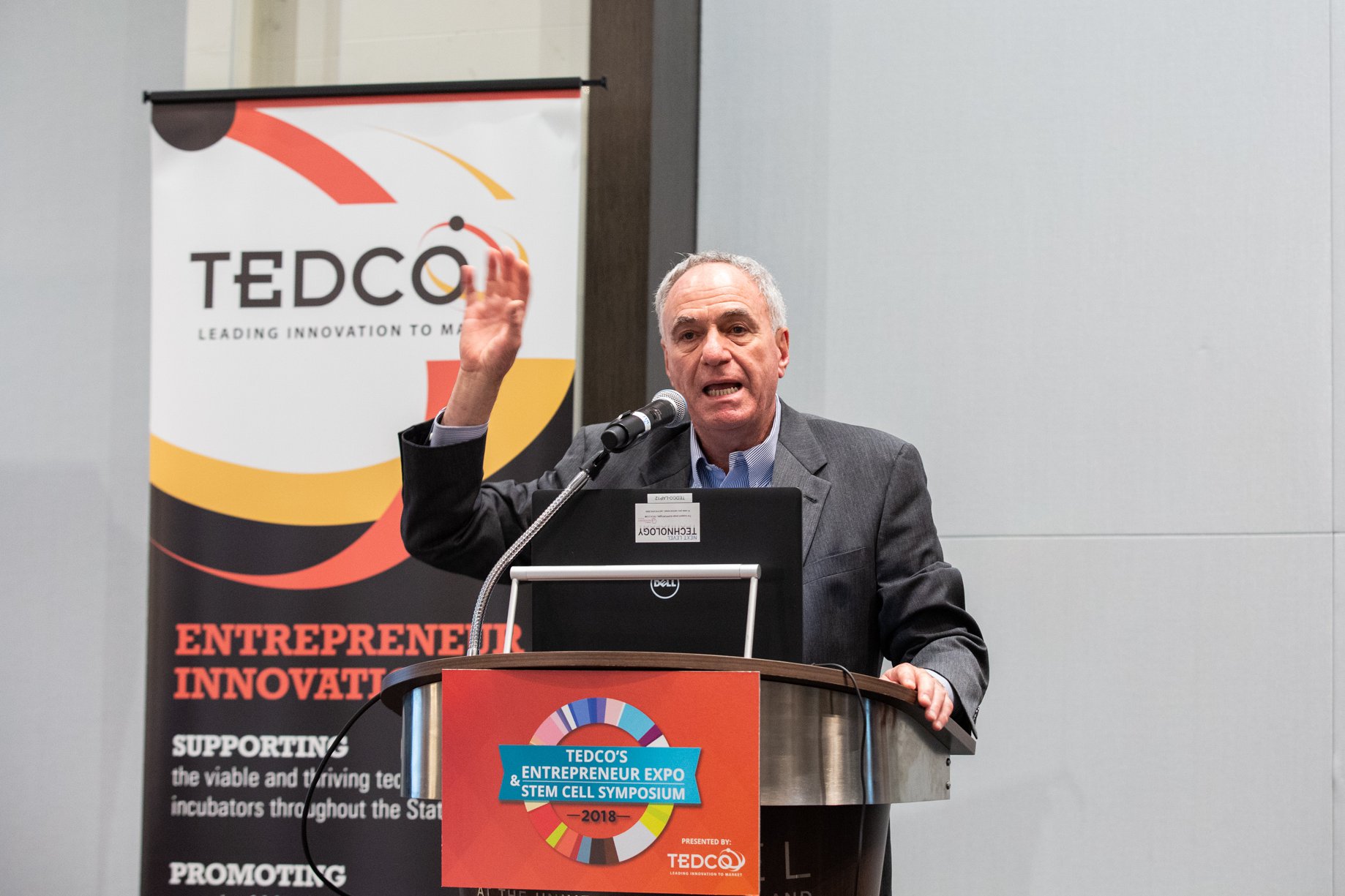 A man speaks at a podium during the TEDCO Entrepreneur Expo and STEM Cell Symposium.