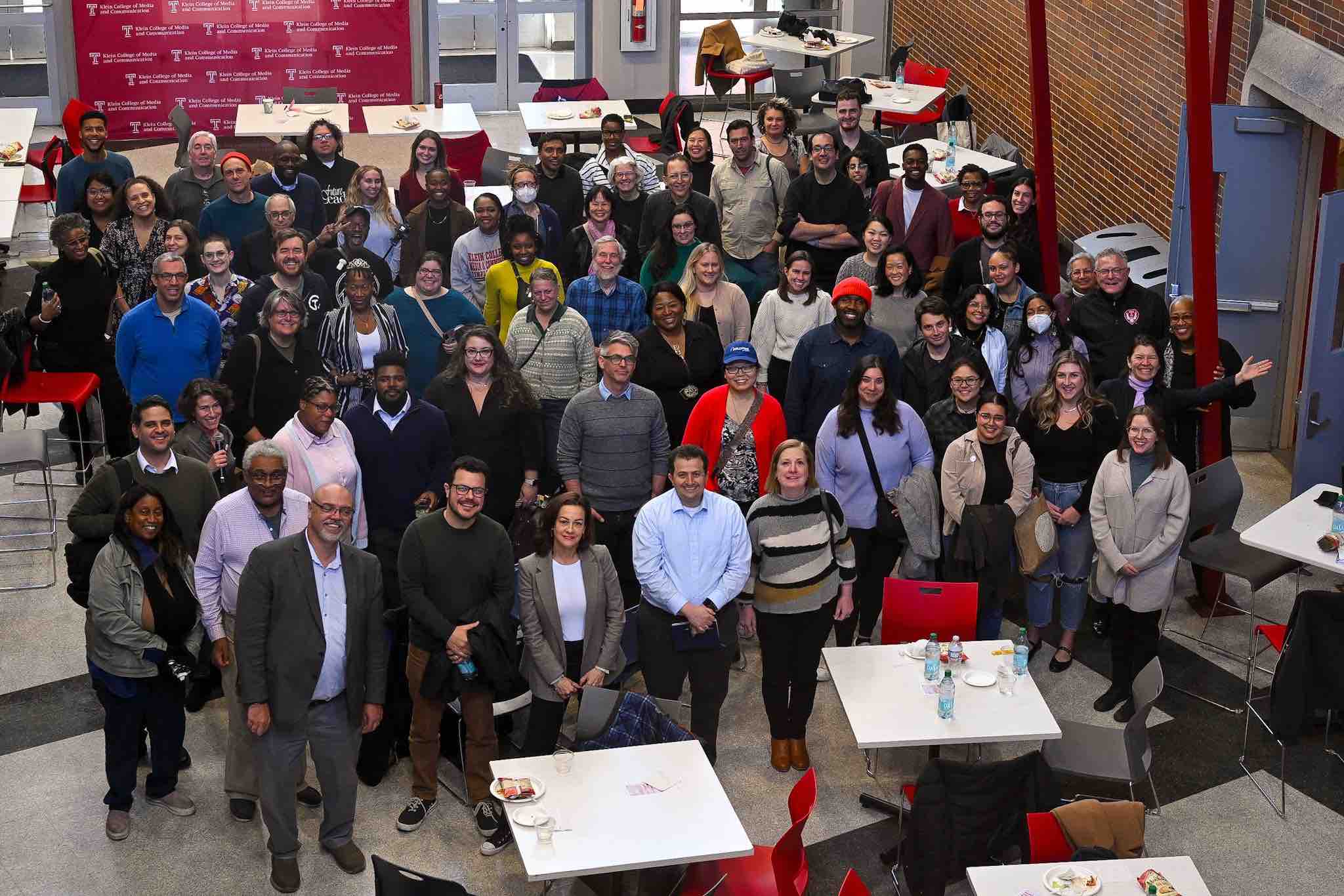 photo of journalists standing in temple university atrium