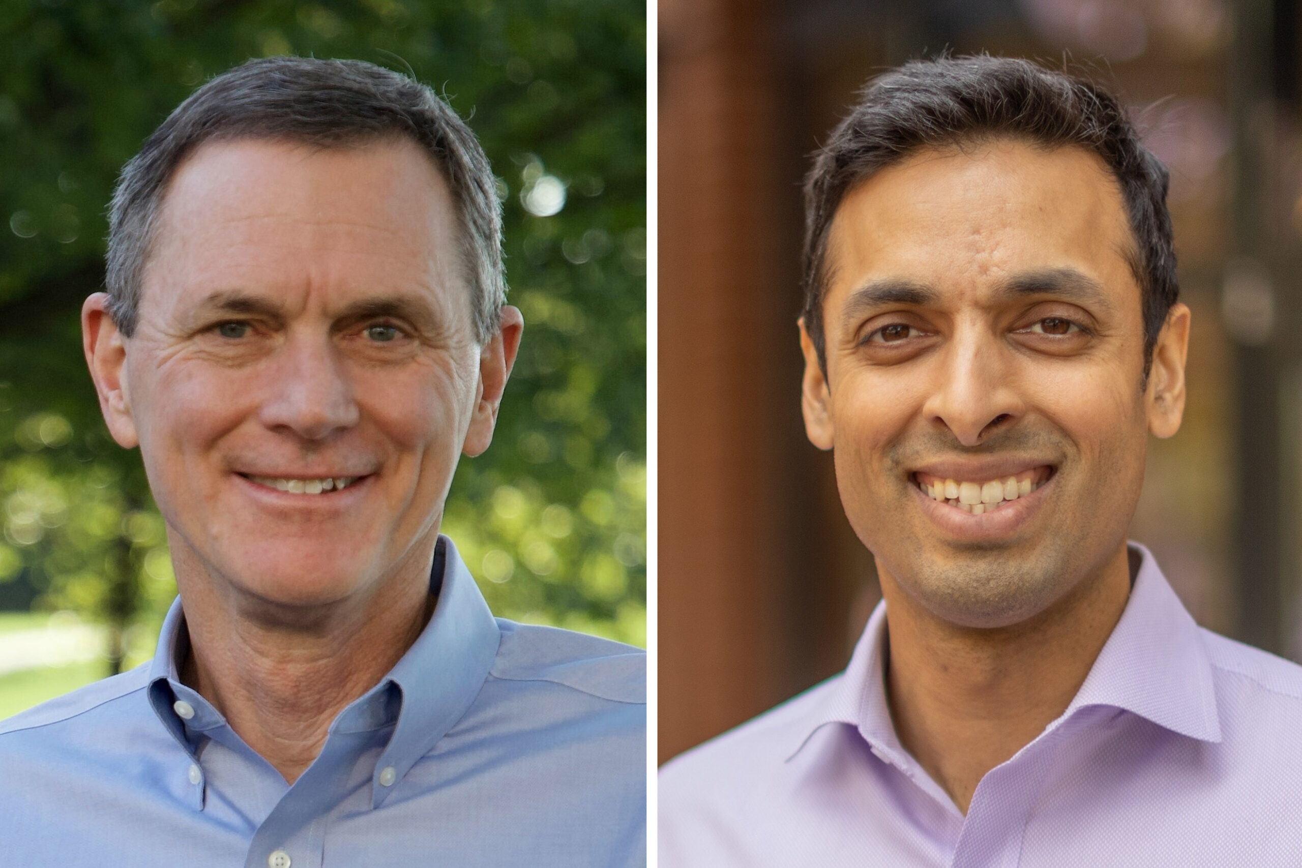 Two men are smiling. The man on the left is wearing a light blue shirt, and the man on the right is wearing a light purple shirt. They are outdoors with greenery in the background.