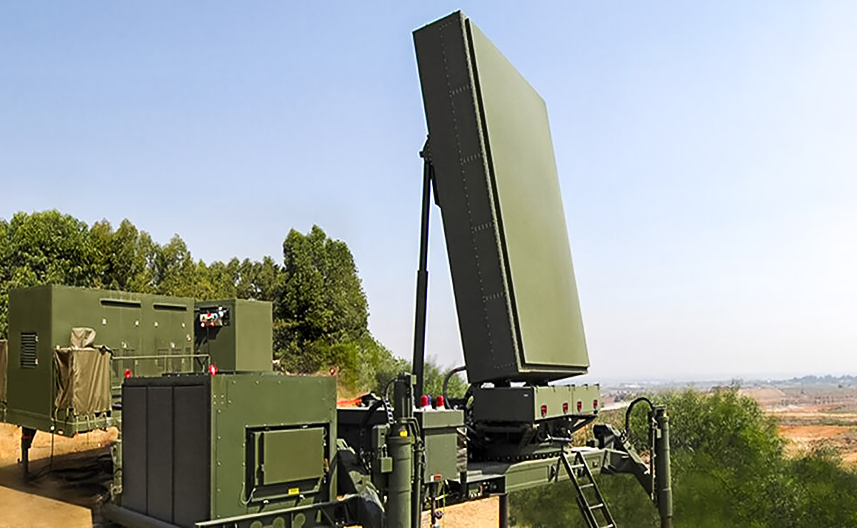 Green radar system sits against a green and brown desert landscape and blue sky.