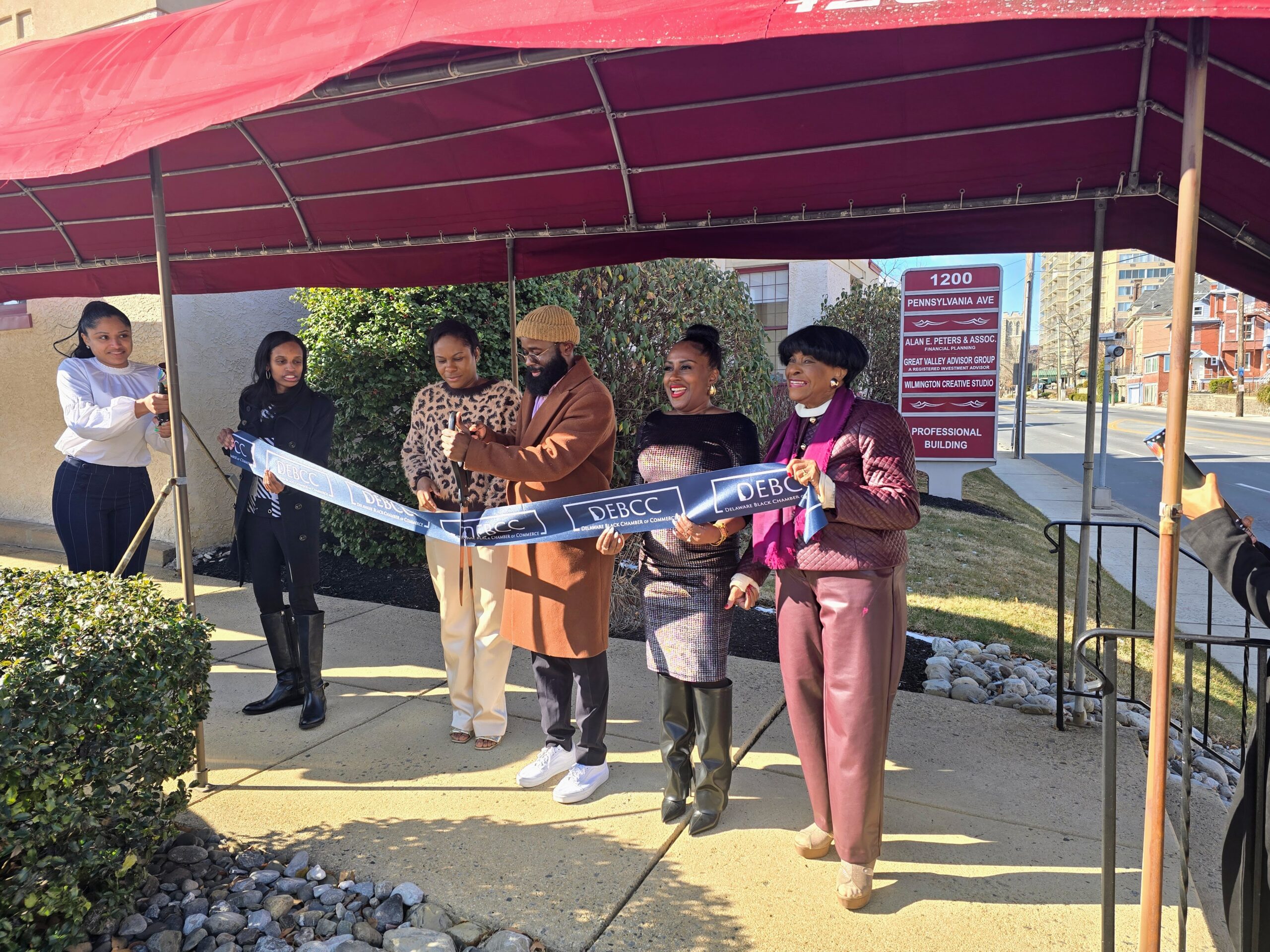 A group of people at a ribbon cutting ceremony