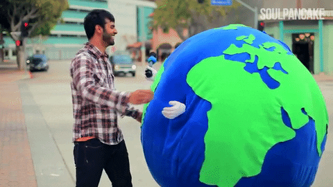 Animated gif of a man hugging a person dressed as the Earth.