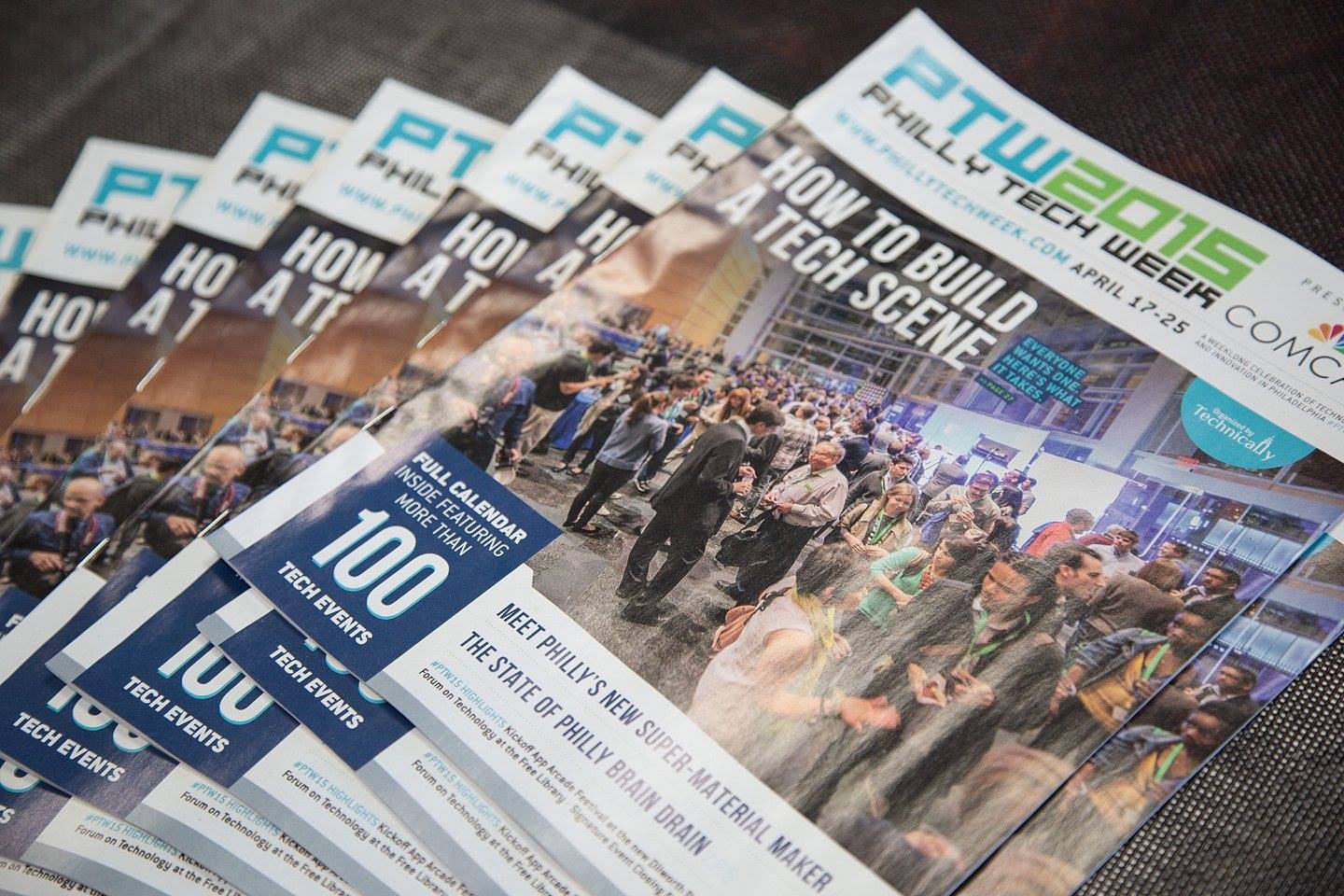 Stack of Philly Tech Week 2016 magazines featuring a cover story titled "How to Build a Tech Scene" with a large crowd at a tech event.