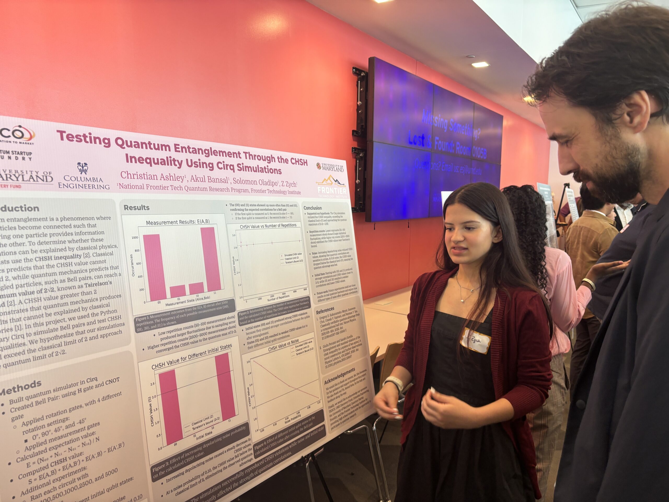 A woman explains a scientific poster about quantum entanglement to a man at a conference; graphs and text are visible on the poster behind her.