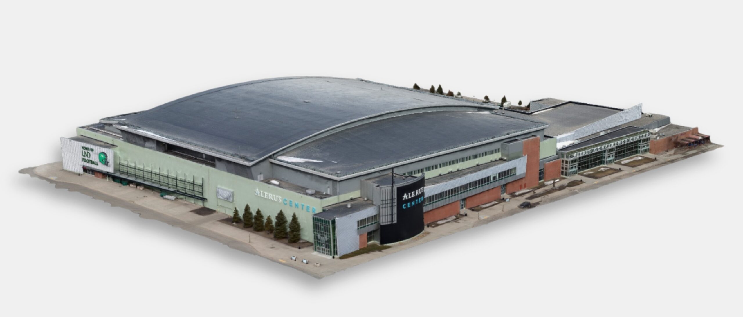 A large indoor arena with a curved roof, green and grey exterior walls, glass entrances, and parking areas surrounding the building.
