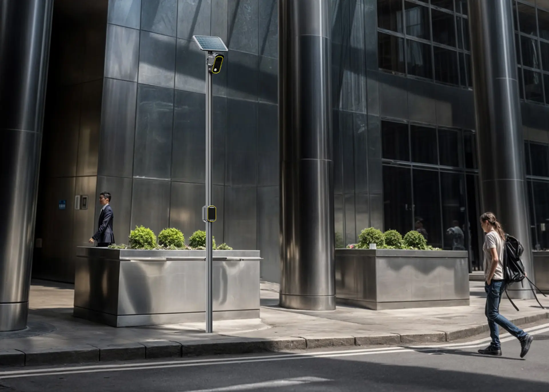 A person with a backpack walks on a city sidewalk near modern steel buildings; a solar-powered streetlight is visible.