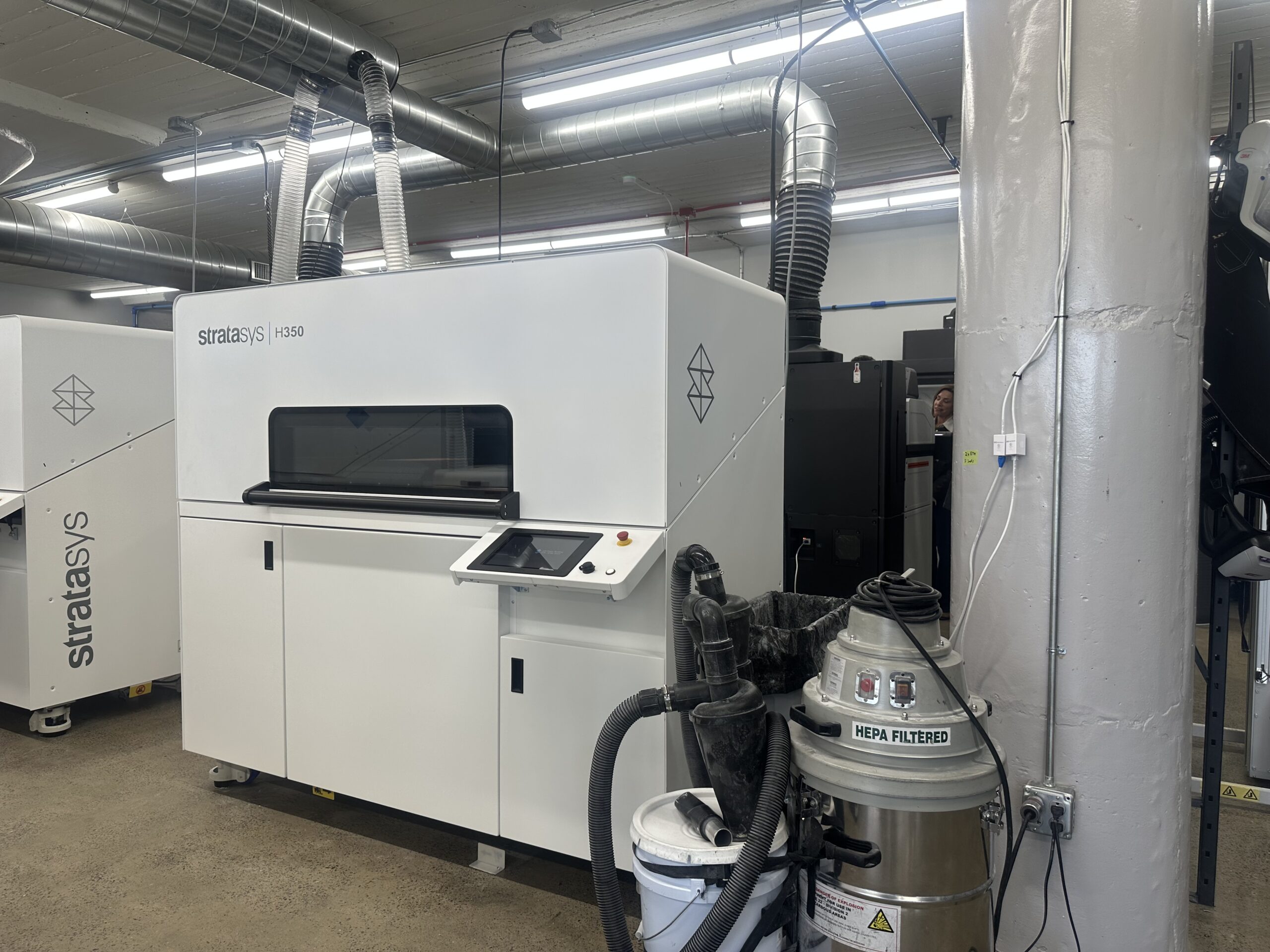 Stratasys H350 3D printer in a workshop next to a HEPA filtered shop vacuum.