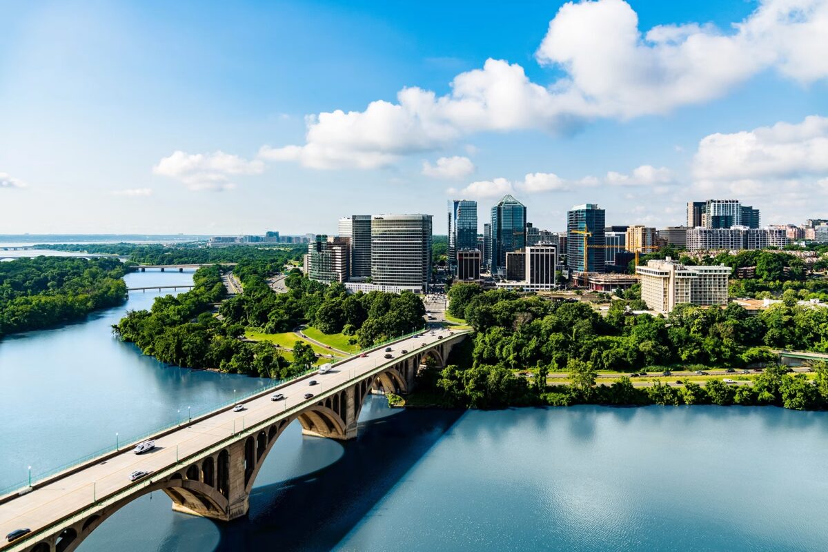 An aerial view of the Key Bridge crossing the Potomac River toward the Rosslyn skyline in Arlington, Virginia.